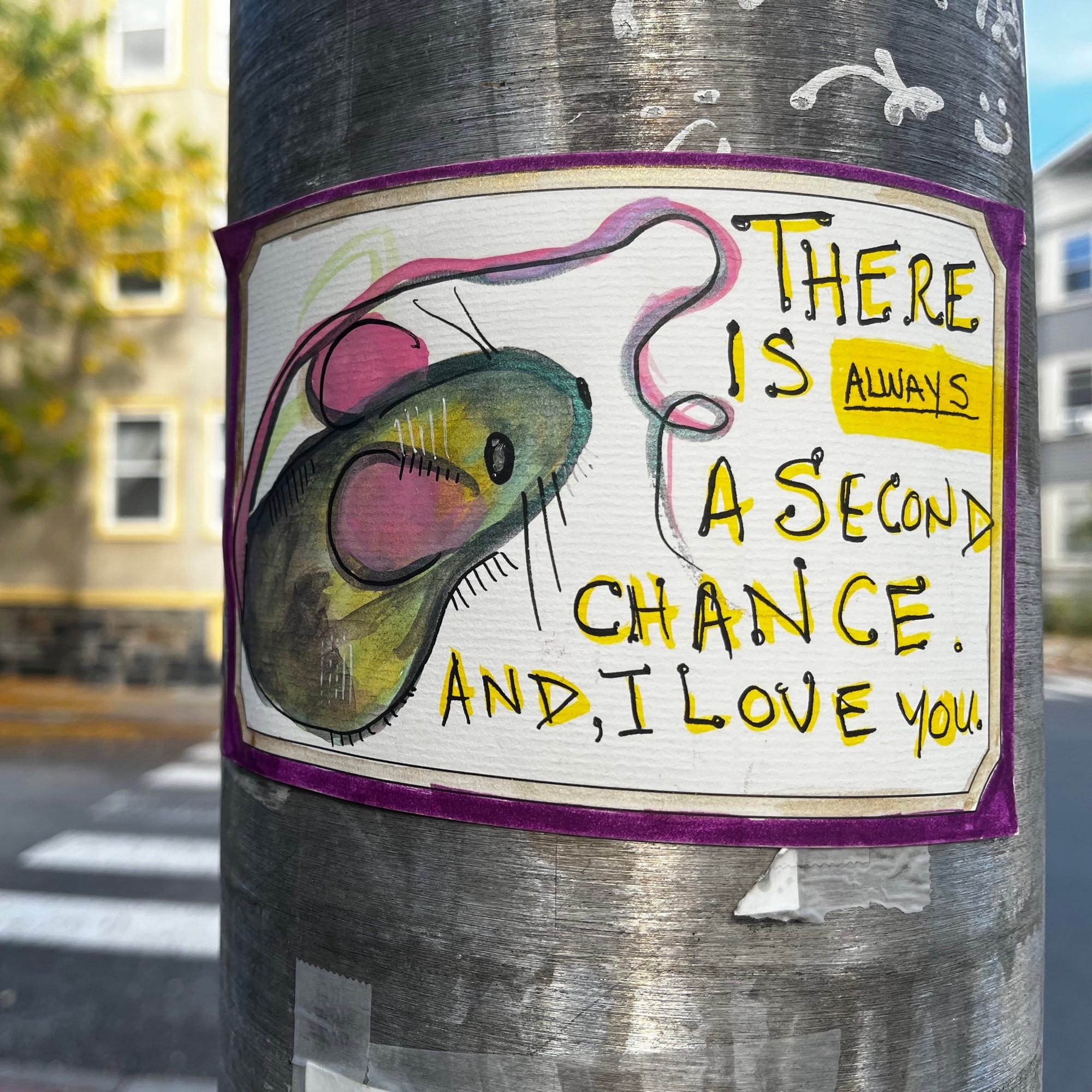 A miniature watercolor painting of a mouse taped to a metal pole. The words: There is always a second chance and I love you are written on it.
