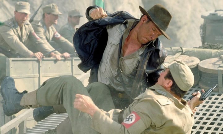 A picture of Indiana Jones, a tenured archeology professor, punching a Nazi in the fucking face.